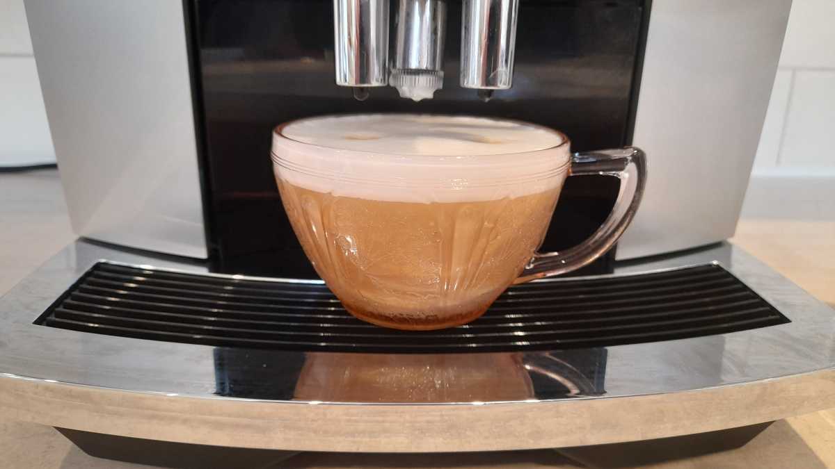 A close view of a cappuccino made by the Jura E6 Coffee Machine.